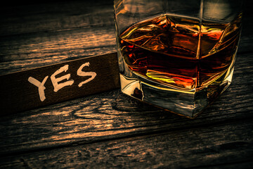 Glass of brandy with the wooden plank on it is an inscription 