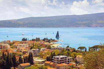 Fototapeta premium Beautiful Mediterranean landscape on sunny spring day. Montenegro, Adriatic Sea, view of Bay of Kotor near Tivat city. Sailboats on water