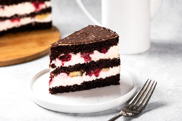 Raspberry cake with chocolate. Chocolate cake with berries. Piece of cake on a plate. Dessert on white background. Black forest cake