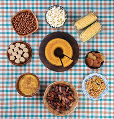 Typical brazilian june festival food over colorful textile. Festa junina