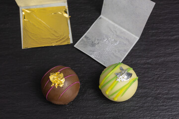 edible gold and silver leaf transfered on chocolate truffles