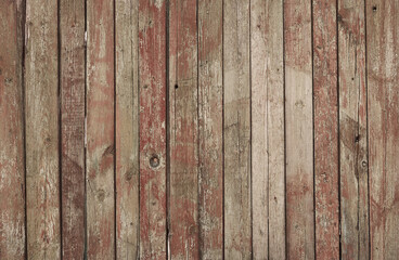 Red coated wood background. Cracked paint. Aged plank wood. Vertical boards covered with cracked paint