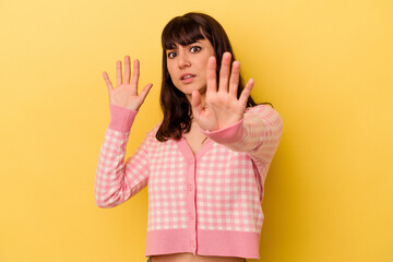 Young caucasian woman isolated on yellow background being shocked due to an imminent danger