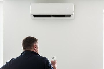 the service technician adjusts the new air conditioner