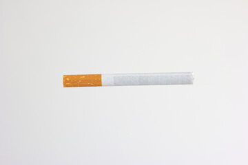 Single unlit cigarette stick with yellow filter studio close up shot isolated on white