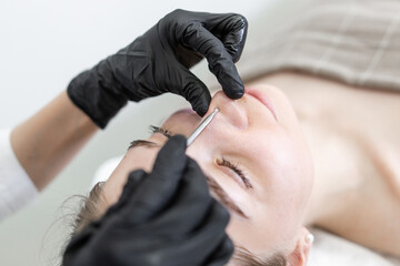 Girl in a beauty salon cleaning the pores on her face