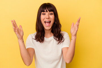 Young caucasian woman isolated on yellow background receiving a pleasant surprise, excited and raising hands.