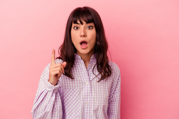 Young caucasian woman isolated on pink background having an idea, inspiration concept.