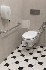 Toilet room with devices for people with disabilities. Public wc for disabled people. Handrails for handycapped people