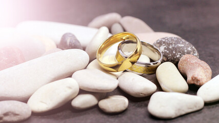 Fototapeta na wymiar Two wedding rings on stones, honeymoon