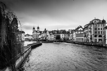 Fototapeta premium Black and white shot of the old town of Luzern, with the Reuss river in the center