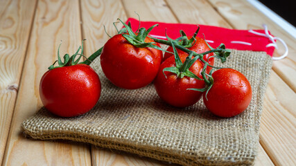 Lots of tomatoes on wooden table