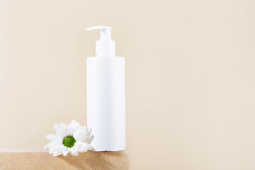 white cosmetic tube on beige stand, white flower, vertical frame