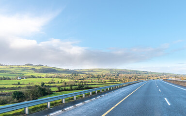 Fototapeta na wymiar Motorway with no traffic on sunny day. Lockdown in Ireland.