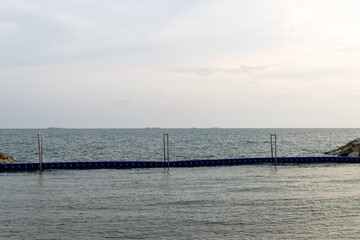 Wave barrier tank. Beach wave barrier. beach broken by sea waves.