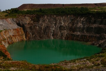 view of the quarry and the green lake at its bottom
