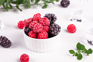 Fresh raspberries and blackberries with frost. Fresh berries. Ice. Mint.