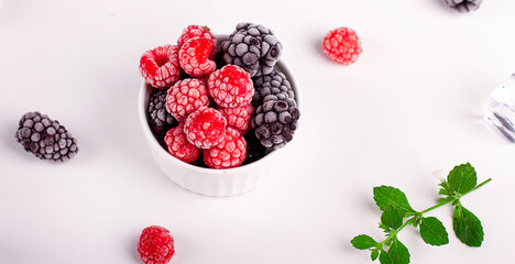 Fresh raspberries and blackberries with frost. Fresh berries. Ice. Mint.