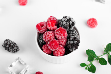 Fresh raspberries and blackberries with frost. Fresh berries. Ice. Mint.