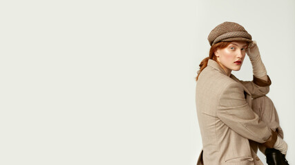 Retro studio portrait of a beautiful Gatsby woman with ginger hair.