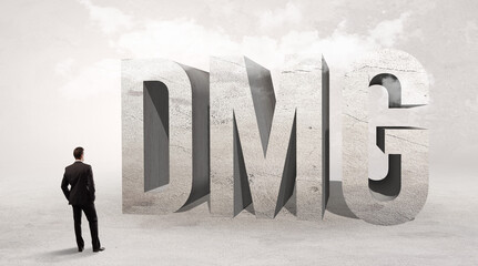 Fototapeta premium Rear view of a businessman standing in front of abbreviation