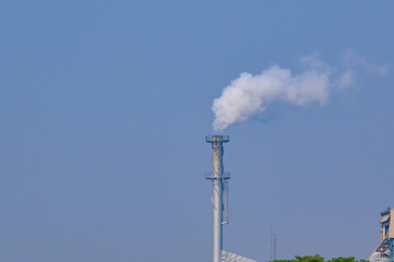Smoke from factory chimneys. Emissions of air pollution and cause global warming.