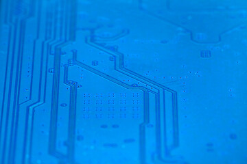 Back side of electronic board with tracks from electronic device. Selective focus.