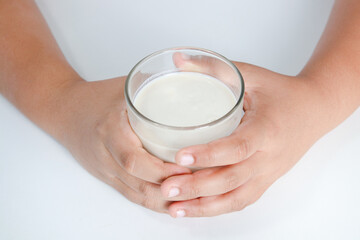 Fat boy holding a full glass of milk. Children are drinking milk. The concept of healthy eating It is beneficial for the growth of children.