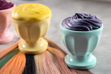 Hair paints samples and hair samples on grey background, hairdresser tools, horizontal