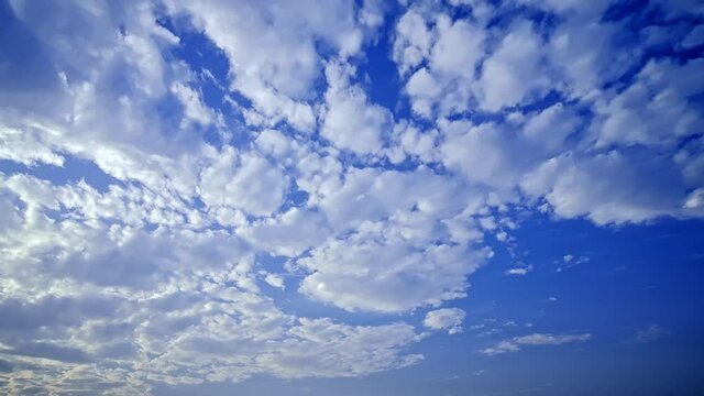 Time lapse of white clouds moving in the blue sky