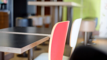 Red and white chairs and black tables