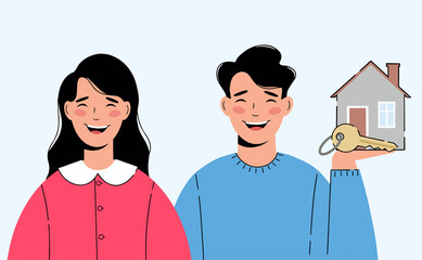 Happy young couple. Man is holding a new house and a key symbolizing the purchase of a house.