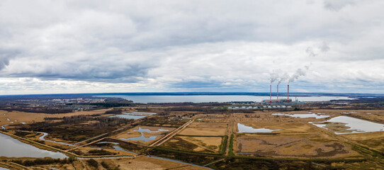 Fototapeta na wymiar Panoramic view of power station Lukomlskaya Gres. Chimneys with smoke of power plant. Ecological problem. Environmental pollution concept.