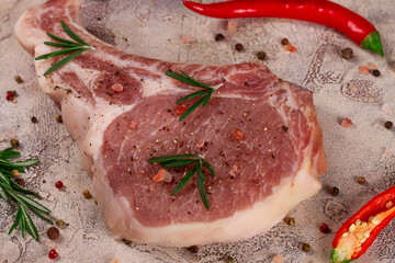 Raw meat for steak with ingredients for cooking on a light background. Bone steak.