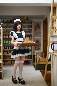 Beautiful cute female waiter servant girl in uniform