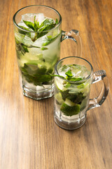 Mojito on rustic wooden background. Frutal alcoholic cocktails. Cuban drinks concept with space for text.