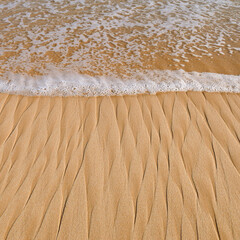 Soft beautiful ocean wave on sandy beach. Background.