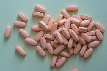 Pink pills on grey background