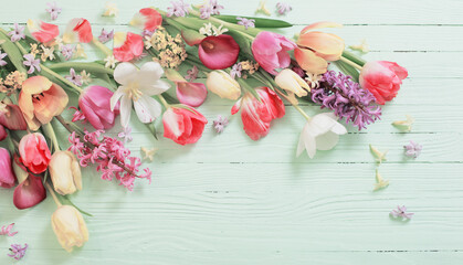 spring flowers on green wooden background