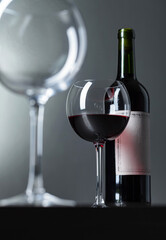 Bottle and glass of red wine .
