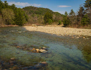 water swirling over rocks on river  

