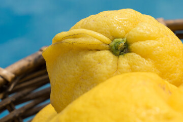 close-up of a bright yellow lemon in a basket minimalist macro