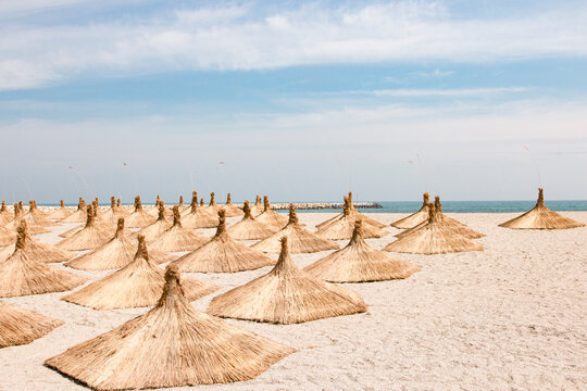  Umbrellas on empty beach during sunny day 