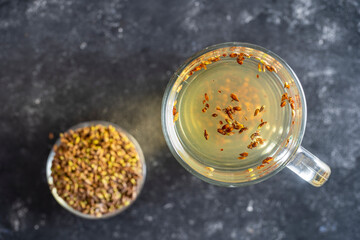 Hot healthy tea with fresh birch buds in spring, close up, top view
