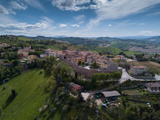 Fototapeta na wymiar Italy, May 2021: aerial view of the medieval village of Sant'angelo in Lizzola in the province of Pesaro and Urbino in the Marche region. Around the hills of the Marche