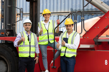 factory workers or engineer team thumbs up pose for successful job in containers warehouse storage