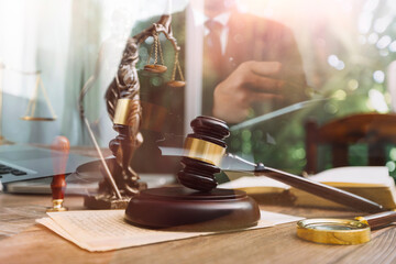Justice and law concept.Male judge in a courtroom with the gavel, working with, computer and...
