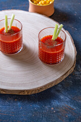 Two Bloody Mary cocktail glasses.