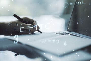 Creative scientific formula illustration with hand writing in diary on background with laptop, science and research concept. Multiexposure