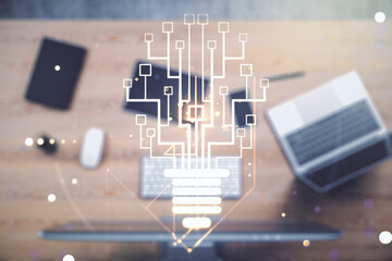 Double exposure of creative light bulb hologram with chip on laptop background, idea and brainstorming concept